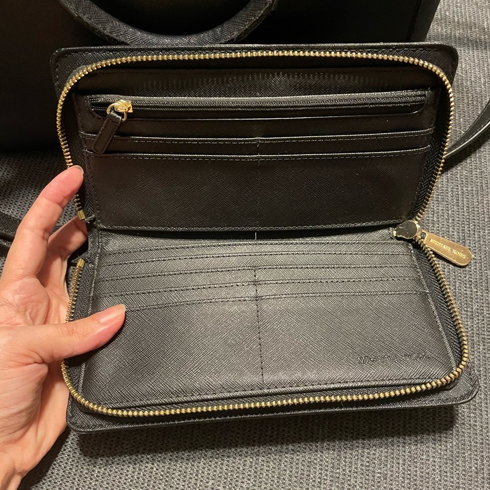 Black Michael Kors handbag and matching wallet with attachable, longer strap.